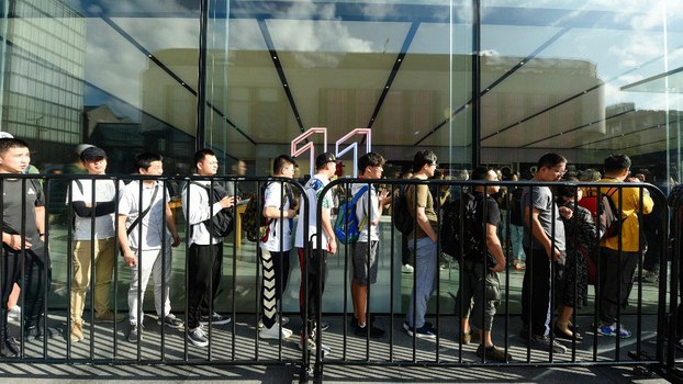 Customers queue outside an Apple store to buy the latest iPhone models in Hangzhou in China's eastern Zhejiang province on Sept. 20, 2019.
