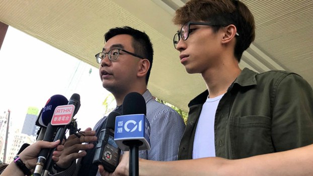 Hong Kong Civil Human Rights Front vice convenors Eric Lai (L) and Figo Chen (R) hold news conference on the previous day's bloody hammer attack on the group's convenor, Jimmy Sham, Oct 17, 2019.