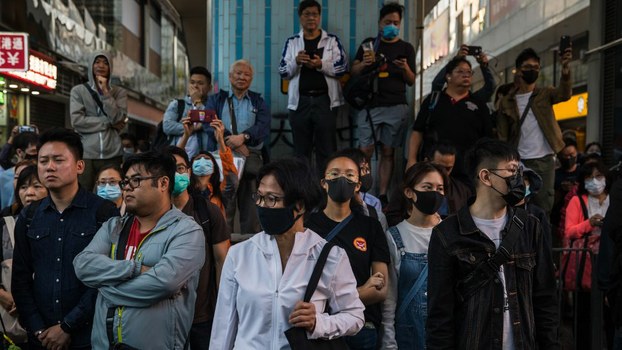 People gather near a police-cordoned-area to show support for a small group of protesters barricaded for over a week inside the Hong Kong Polytechnic University campus, Nov. 25, 2019.
