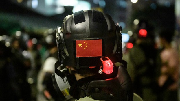 A Chinese flag is displayed on the back of the helmet of a riot police officer during a pro-democracy demonstrator in Yuen Long district of Hong Kong, Oct. 21, 2019.