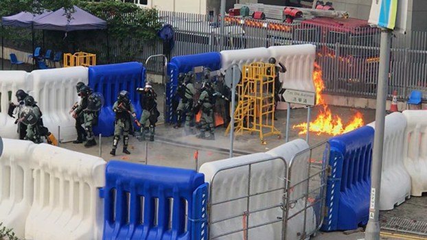 Police line up at Hong Kong government headquarters after some protesters threw Molotov cocktails, Sept 15, 2019.