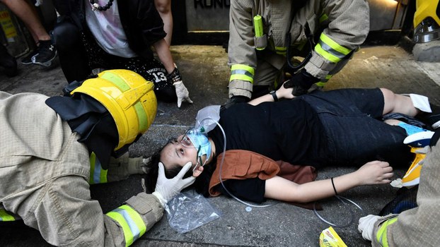 A protester receives medical assistance after a taxi hit two protesters during a demonstration in Hong Kong, October 6, 2019. 