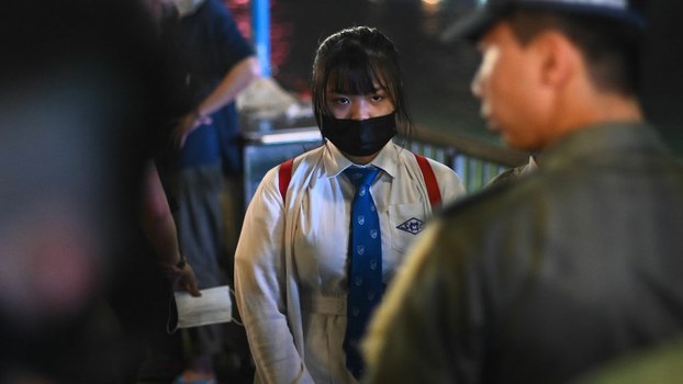 A high school student (C) is checked by police at a nearby rally to mark Taiwan's National Day, in the Tsim Sha Tsui district in Hong Kong, Oct. 10, 2019. 