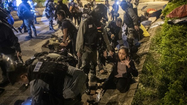 Police detain protesters and students after they tried to flee outside the Hong Kong Polytechnic University campus in the Hung Hom district of Hong Kong, Nov. 19, 2019.