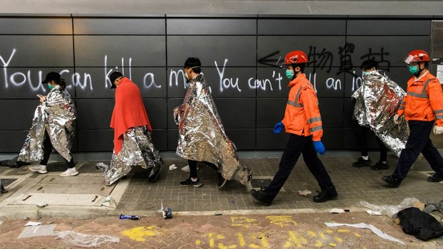 Anti-government protesters are taken by paramedics to ambulances from the campus of the Hong Kong Polytechnic University (PolyU) after being barricaded inside for days, in the Hung Hom district of Hong Kong,Nov. 20, 2019. 