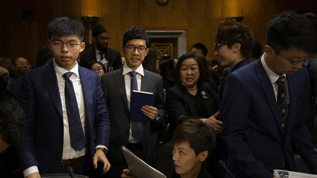 Hong Kong pro-democracy activists Joshua Wong (L), Nathan Law (2nd L) and Hong Kong Cantopop singer and activist Denise Ho (C, bottom) leave after a hearing before the Congressional-Executive Commission on China in Washington, Sept. 17, 2019.