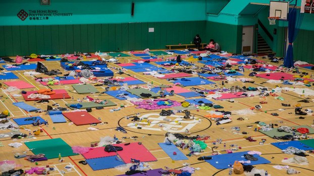 A dwindling core of protesters rest inside a sports hall after days of siege at Hong Kong Polytechnic University in Hong Kong, Nov. 21, 2019. 