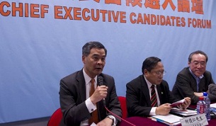 Leung Chun-ying (l) speaks as the other chief executive candidates Albert Ho (c) and Henry Tang (r) look on at a forum in Hong Kong, March 12, 2012.