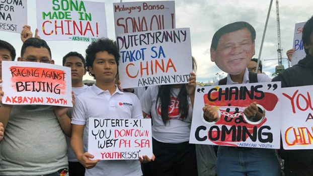 Filipino student activists hold placards and signs against China during a protest rally in Manila, July 22, 2019.