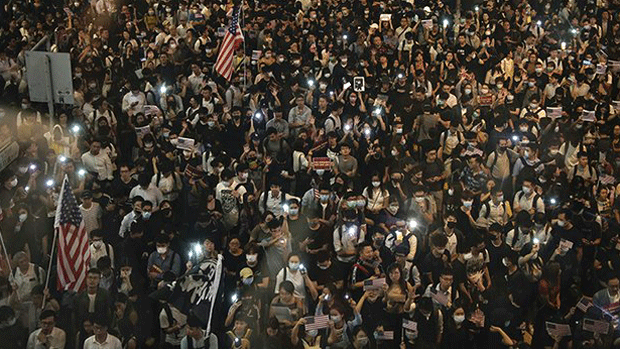 Hong Kong residents display US flags at mass protest rally, Oct. 14, 2019.