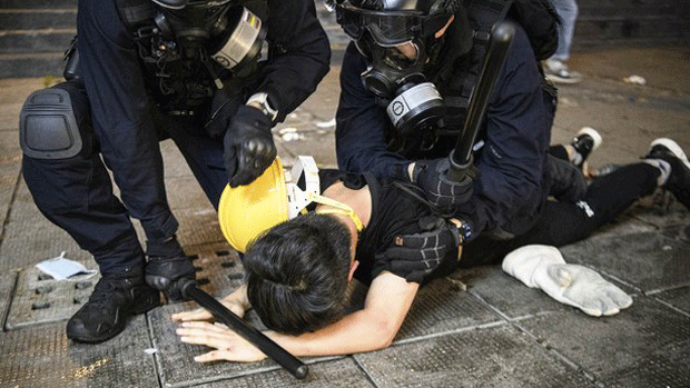 Hong Kong police subdue a pro-democracy protester in an Aug. 11, 2019 photo.