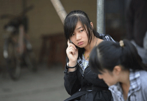 Xue Jianwan, daughter of a local leader who died in police custody from the rebel Chinese village of Wukan, talks on the phone, Dec. 15, 2011.