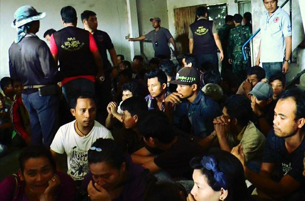 Sixty-two migrants from Myanmar wait at a house in Padang Besar, Thailand, to be taken into police custody, Aug. 2, 2016.