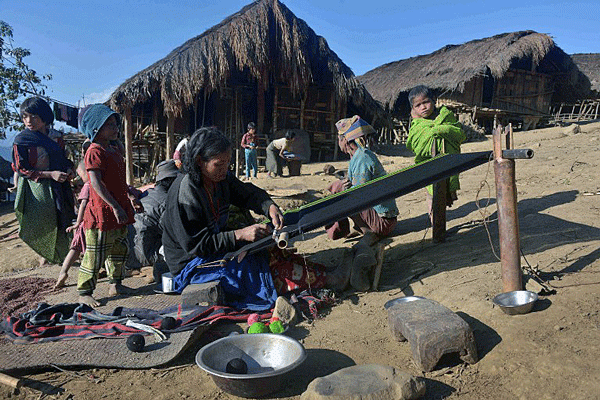 An ethnic Naga woman weaves cloth in a village in Lahe township, northwestern Myanmar's Sagaing region, Dec. 24, 2014.