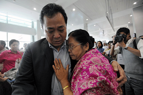 Myanmar academic Aung Thu Nyein, who fled a brutal crackdown on student protesters in 1988, is greeted by his mother upon his return to his homeland at Yangon international airport, Feb. 10, 2012.
